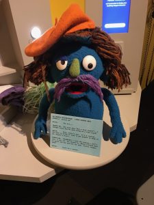 Muppet character with long hair and a beret