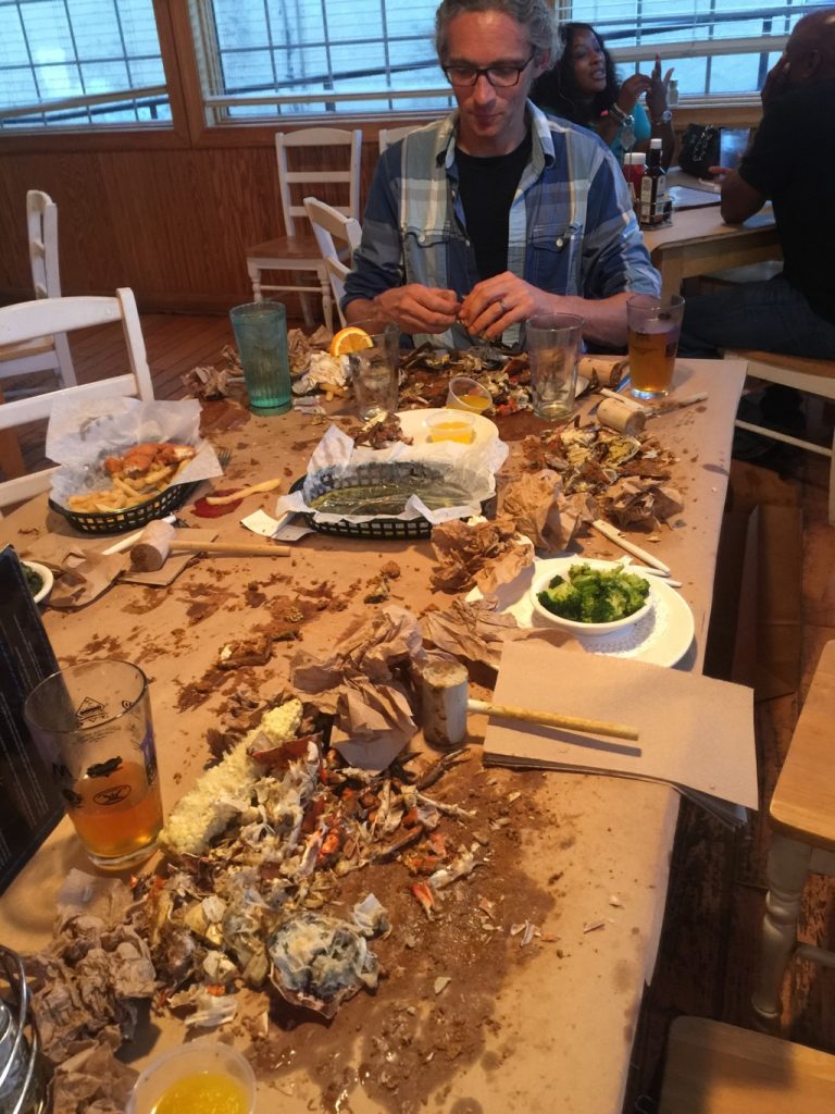 Drummer at the head of the table full of empty crab shells